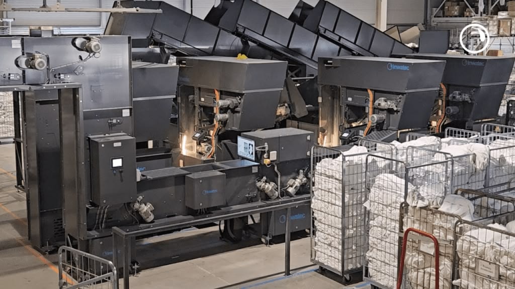 Row of Inwatec robotic sorting machines on the factory floor in Odense