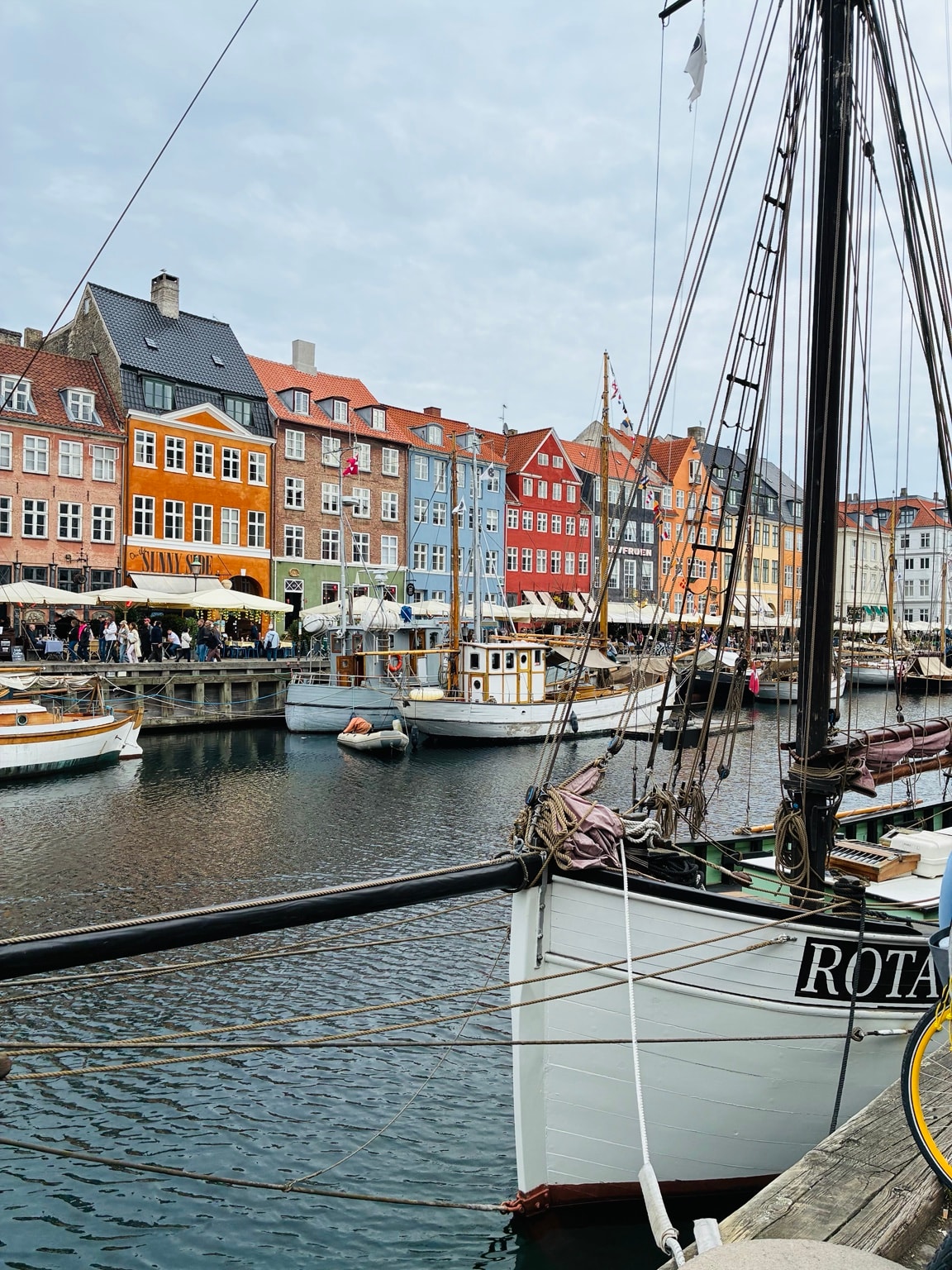Nyhavn harbour in Copenhagen with colourful buildings and historic sailing boats